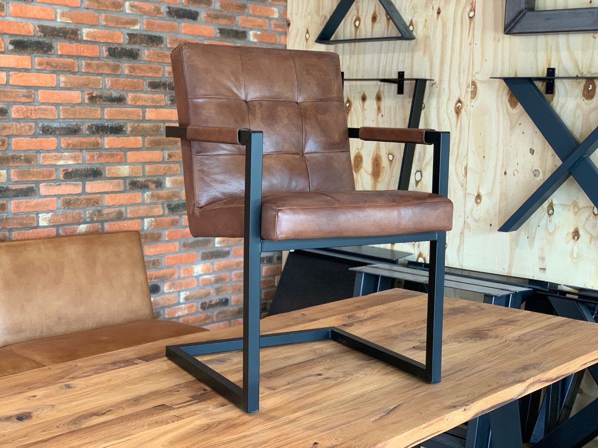 Freischwinger Lederstuhl Braun mit Rautensteppung und Armlehnen Aufnahme aus dem Showroom